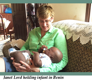 Janet Lord holding infant in Benin