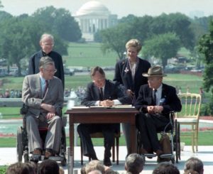 George H.W. Bush signing the Americans with Disabilities Act.