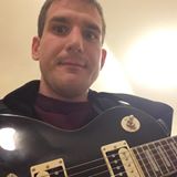 Benjamin Jones holding his guitar