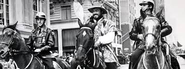 (Photo: Luciano Pavarotti on a horse, flanked by two mounted New York City police officers.)